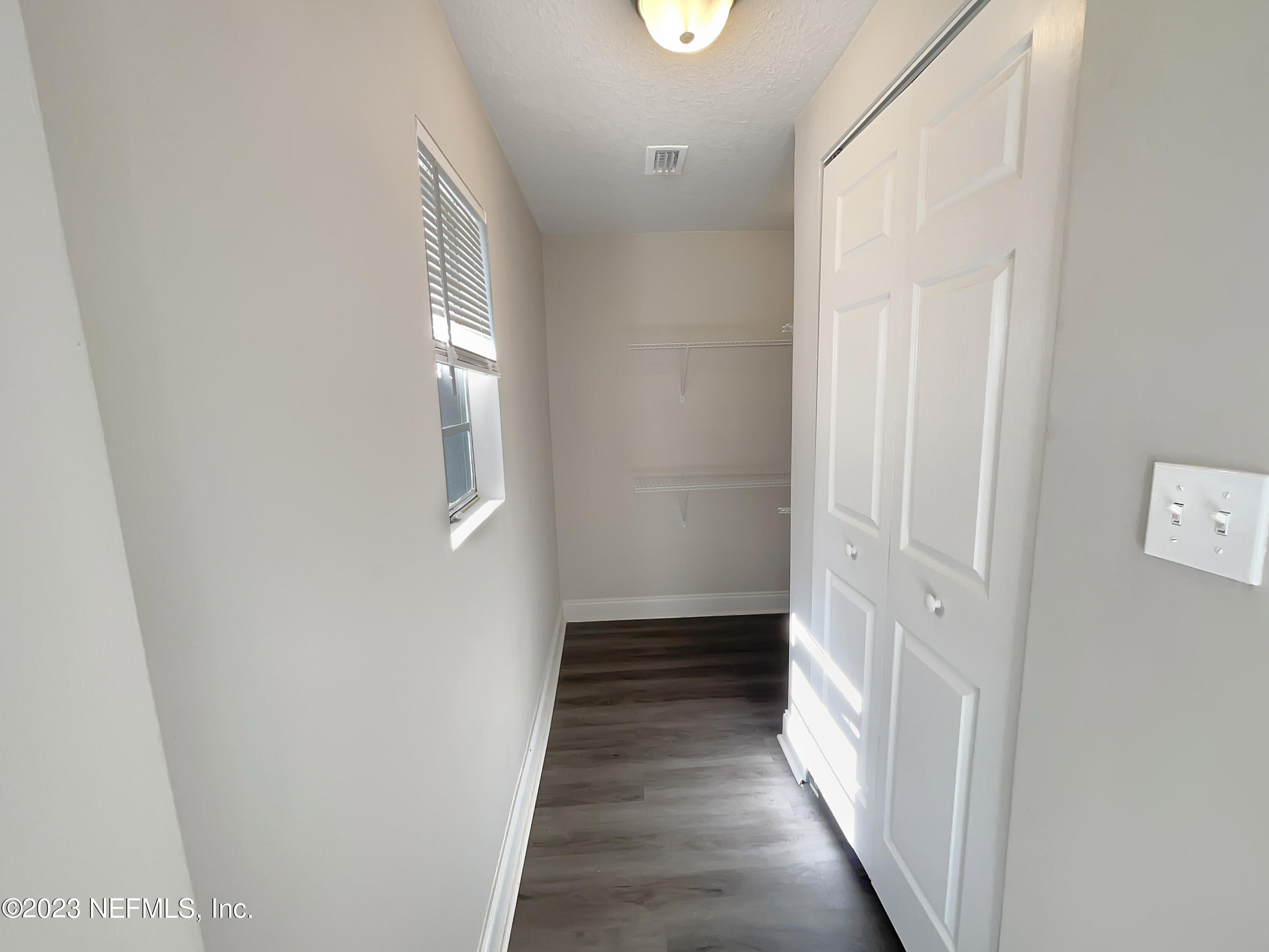 1820 Leonid Road Jacksonville, FL 32218 - Photo 11 of 21 a view of a hallway with wooden floor and staircase