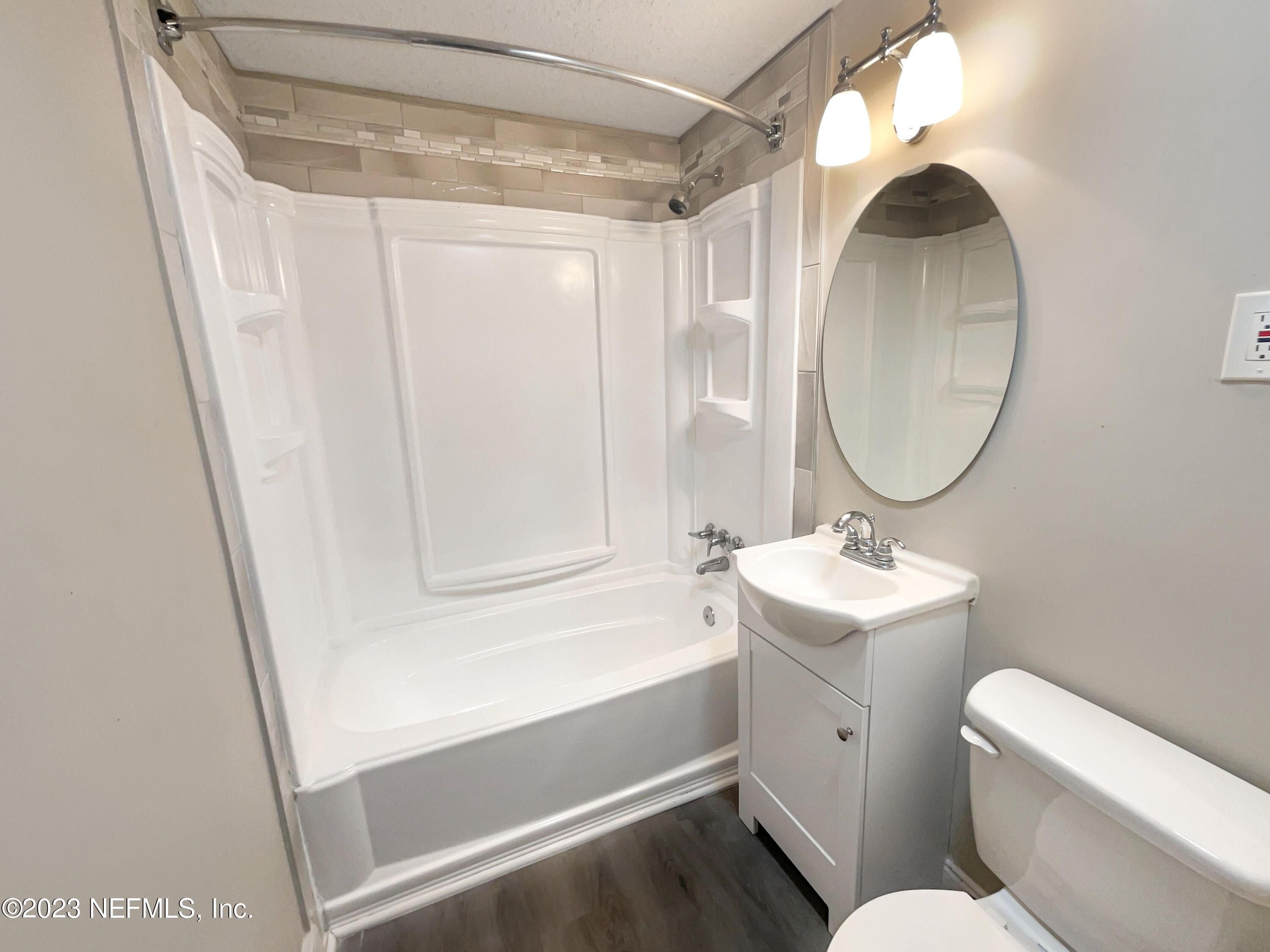 1820 Leonid Road Jacksonville, FL 32218 - Photo 15 of 21 a bathroom with a granite countertop sink toilet a mirror and vanity