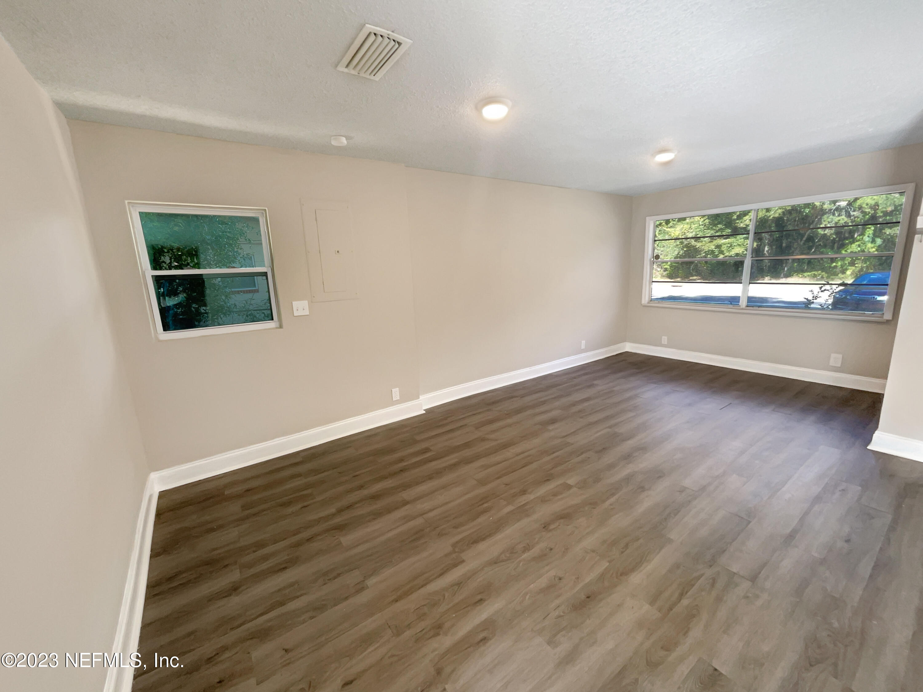 1820 Leonid Road Jacksonville, FL 32218 - Photo 3 of 21 an empty room with wooden floor and windows