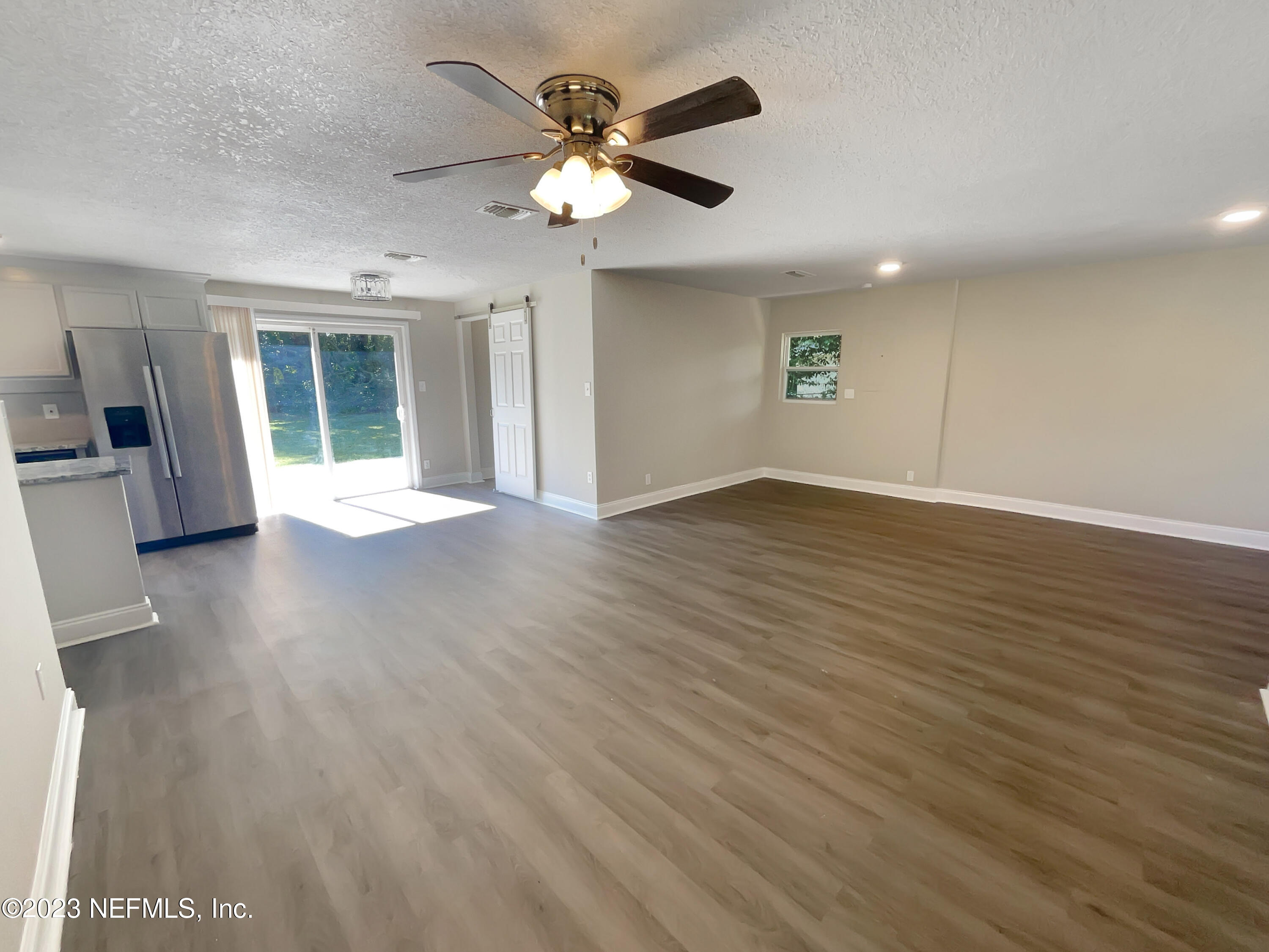 1820 Leonid Road Jacksonville, FL 32218 - Photo 8 of 21 wooden floor in an empty room with a window