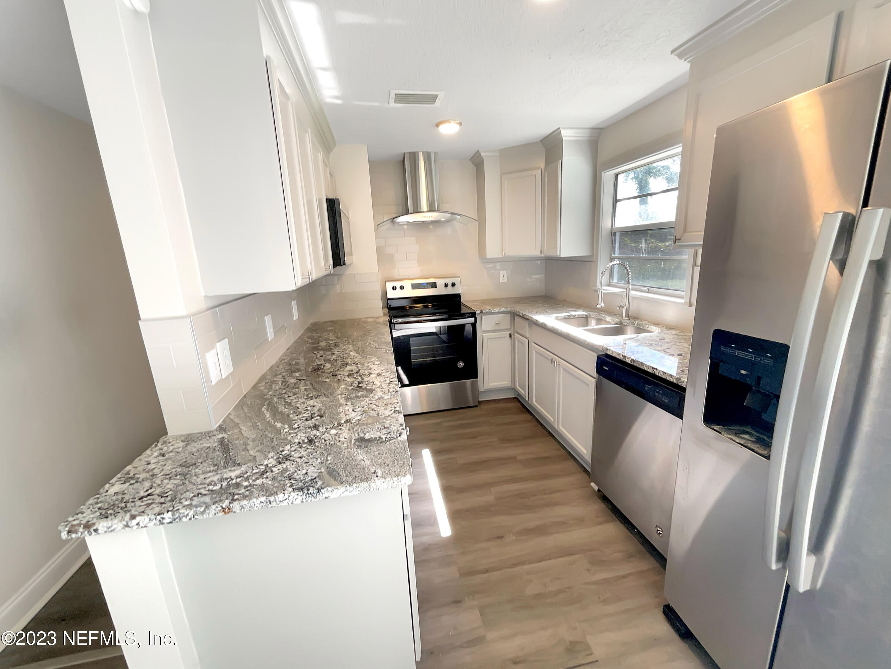 1820 Leonid Road Jacksonville, FL 32218 - Photo 9 of 21 a large kitchen with a stove a refrigerator and a sink