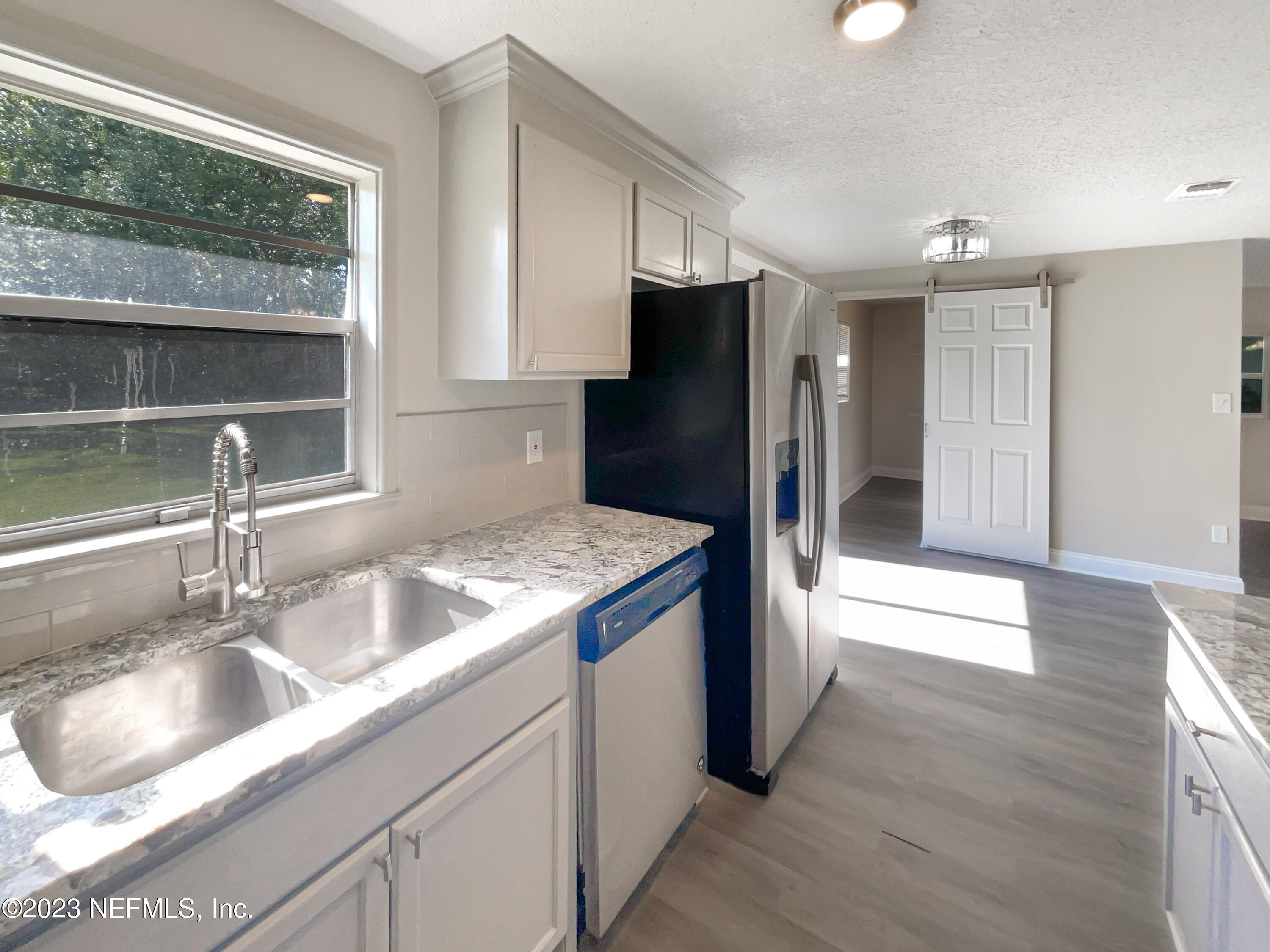 1820 Leonid Road Jacksonville, FL 32218 - Photo 10 of 21 a kitchen with stainless steel appliances granite countertop a sink and a refrigerator