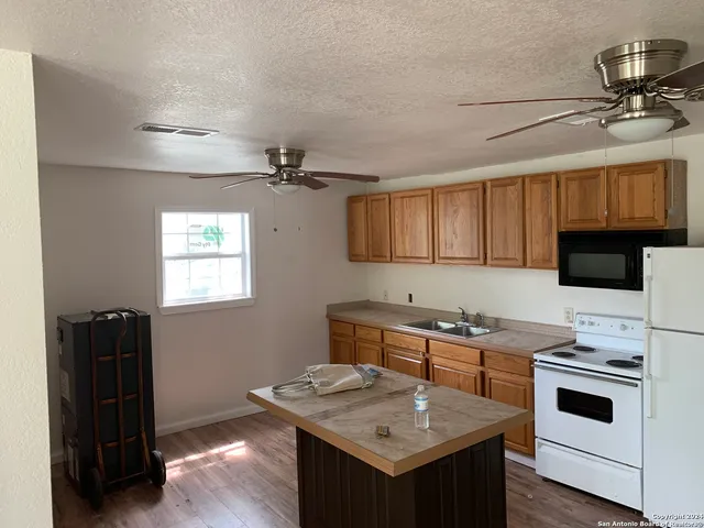 a kitchen with a sink appliances and cabinets