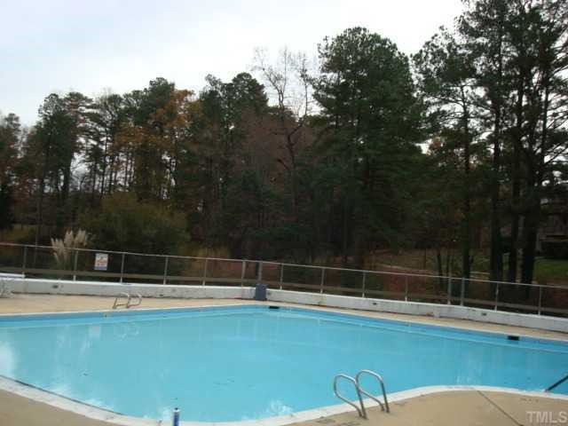 5016 Flint Ridge Place Raleigh, NC 27609 - Photo 11 of 12 a view of a tennis court with lots of trees in the background
