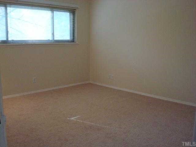 5016 Flint Ridge Place Raleigh, NC 27609 - Photo 5 of 12 an empty room with a window