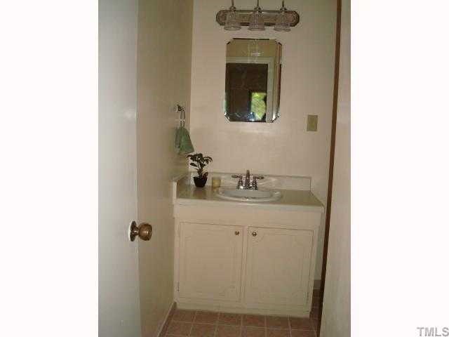 5016 Flint Ridge Place Raleigh, NC 27609 - Photo 6 of 12 a bathroom with a sink and a mirror