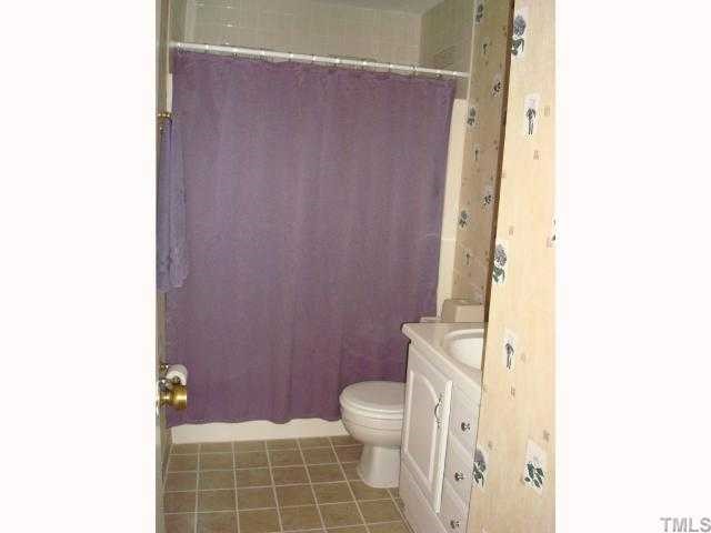 5016 Flint Ridge Place Raleigh, NC 27609 - Photo 8 of 12 a bathroom with a toilet and a shower