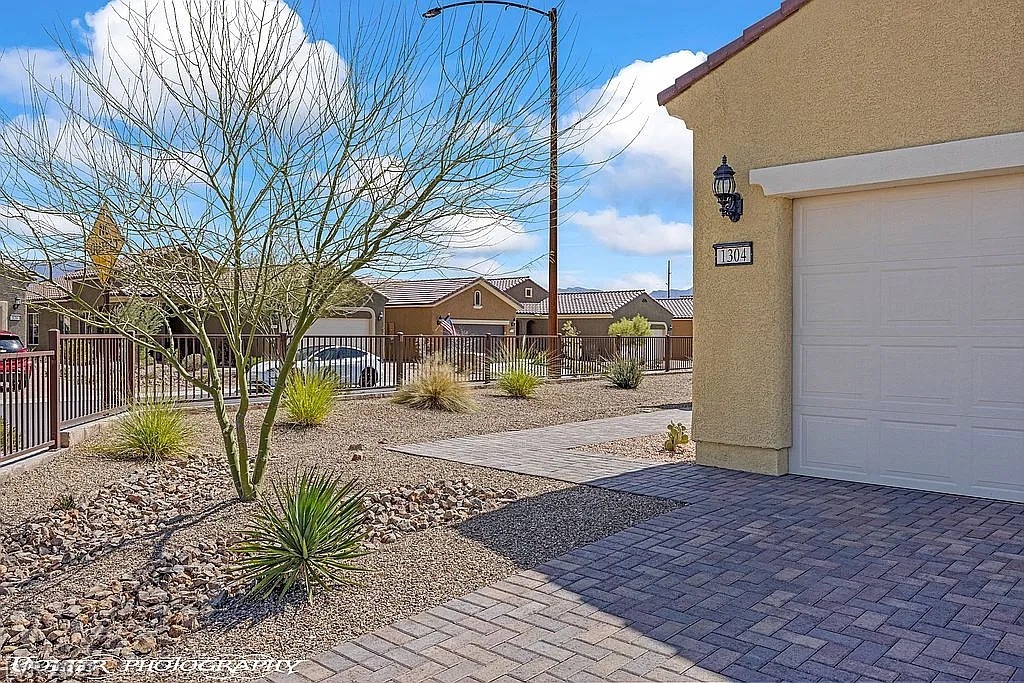 1304 Cottage Ridge Mesquite, NV 89034 - Photo 40 of 52 A desert-friendly front yard features xeriscaping and a paver walkway leading to the entrance.