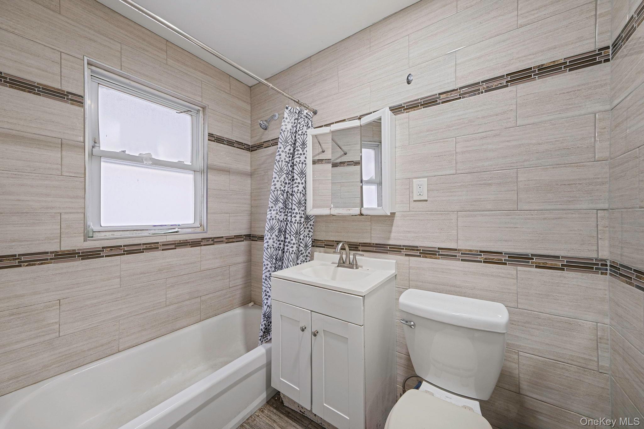 101-19 Lefferts Boulevard Queens, NY 11419 - Photo 12 of 15 a bathroom with a sink toilet and shower