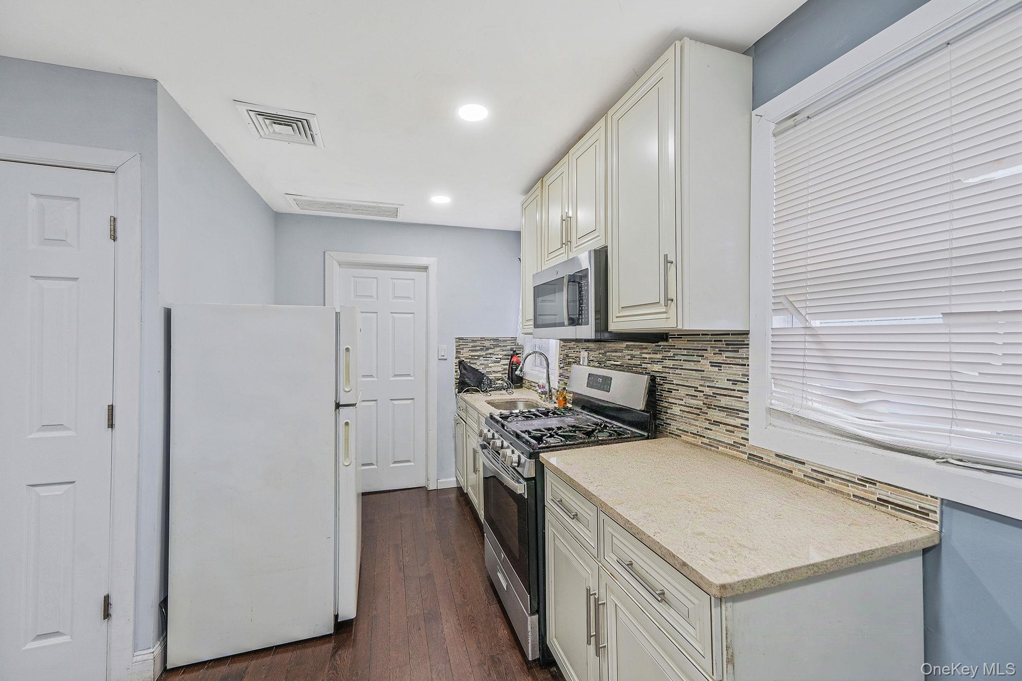101-19 Lefferts Boulevard Queens, NY 11419 - Photo 13 of 15 a kitchen with stainless steel appliances granite countertop a refrigerator a stove and a sink
