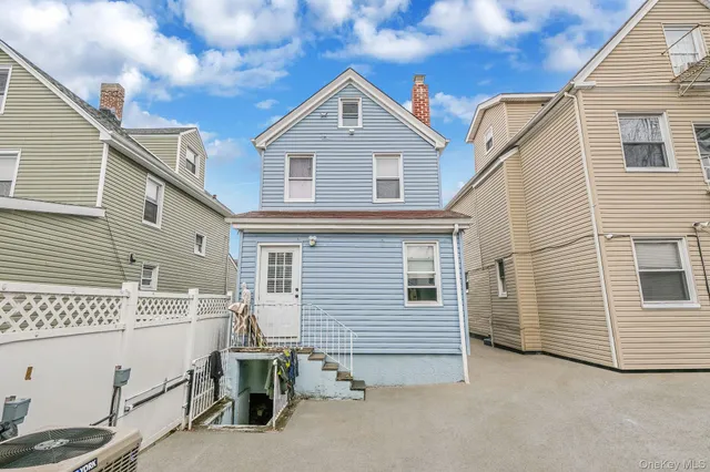 a view of house with roof deck front of house