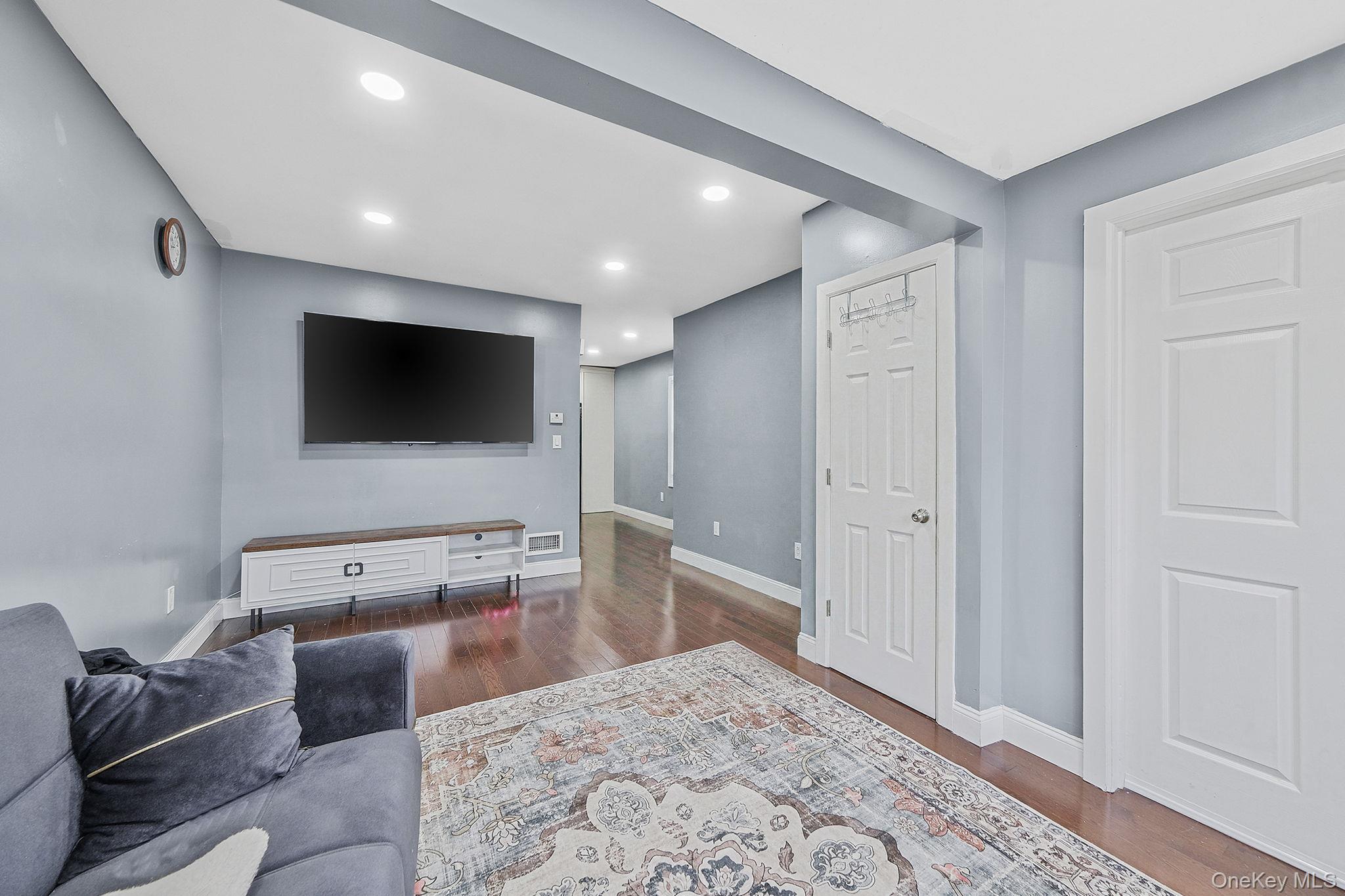 101-19 Lefferts Boulevard Queens, NY 11419 - Photo 6 of 15 a living room with furniture and a flat screen tv