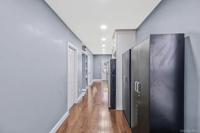 a view of hallway with wooden floor