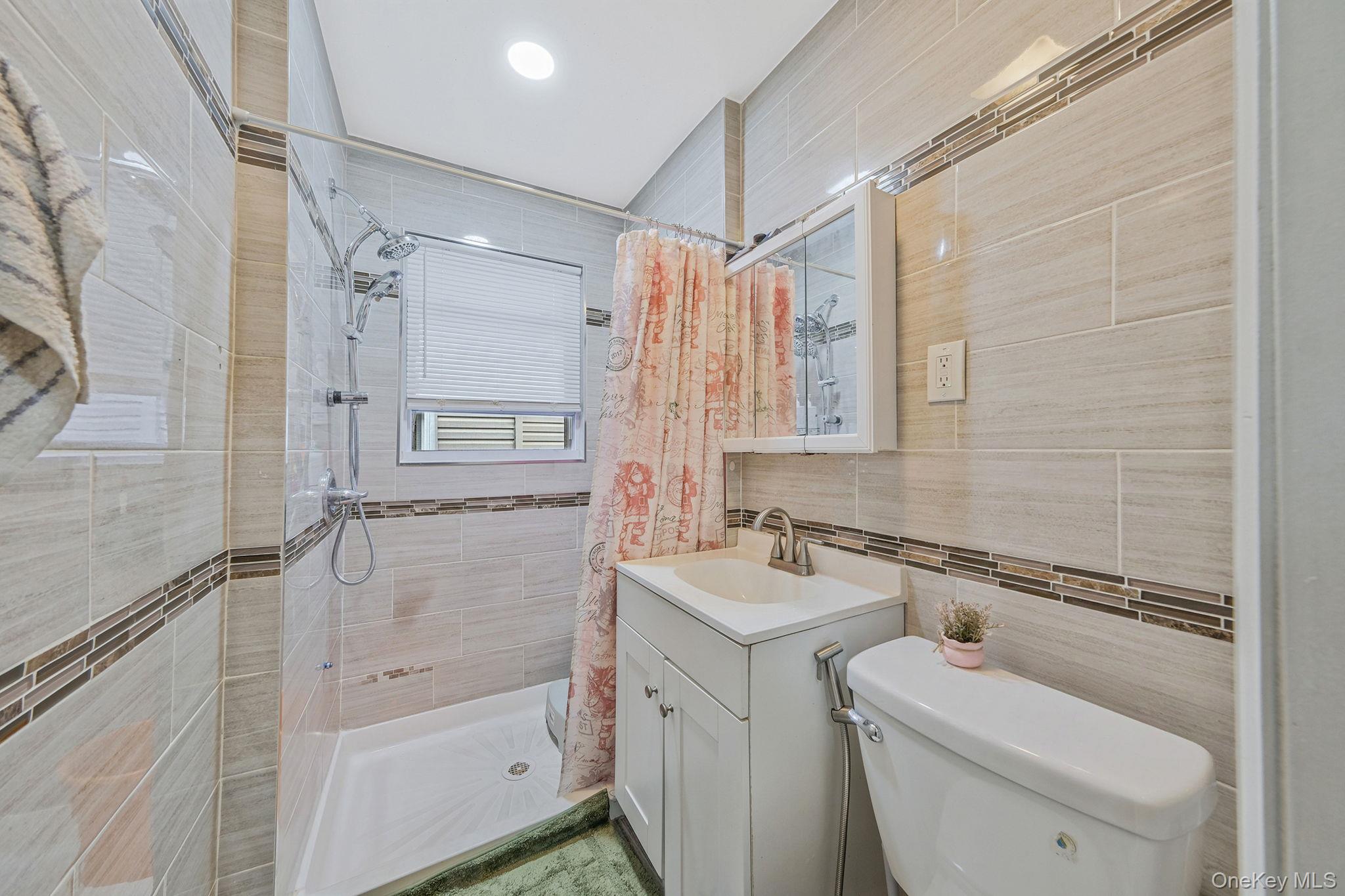 101-19 Lefferts Boulevard Queens, NY 11419 - Photo 10 of 15 a bathroom with a sink a toilet and shower