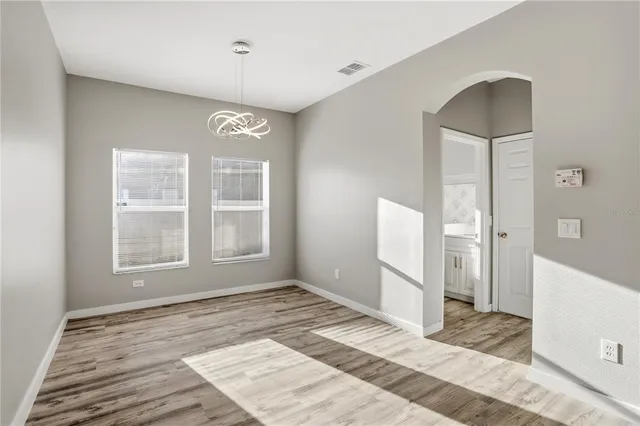 a kitchen with kitchen island a sink and a stove with wooden floor