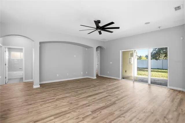 a view of a livingroom with a window and wooden floor
