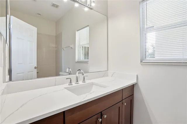 a white toilet and tub sitting next to a bathroom sink