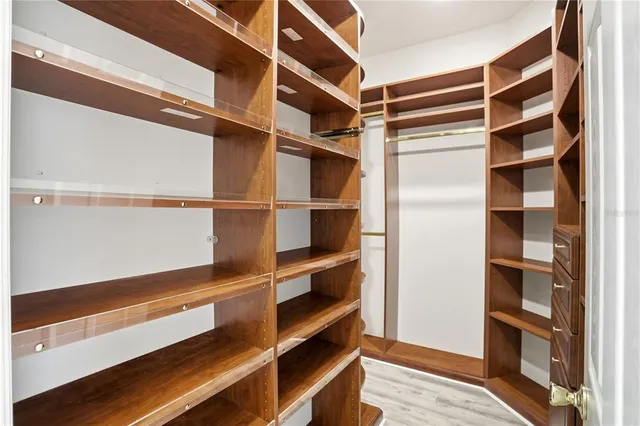 a large bathroom with a granite countertop double vanity and a large mirror
