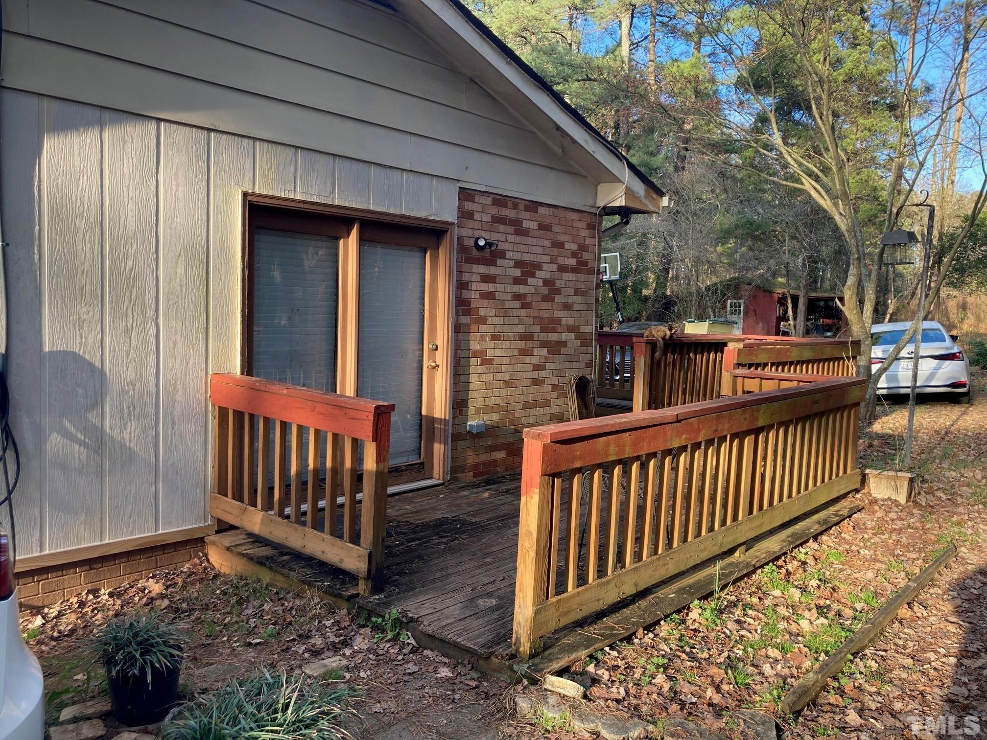 11512 Hickory Grove Church Road Raleigh, NC 27613 - Photo 13 of 17 a view of a porch with wooden floor and iron fence