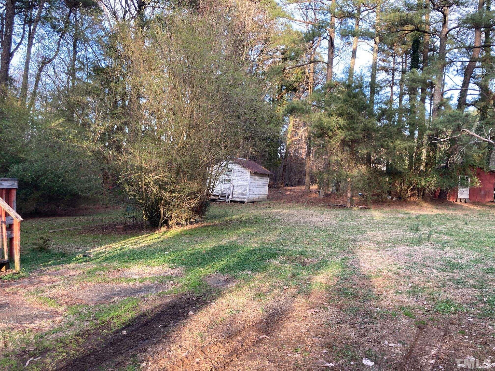 11512 Hickory Grove Church Road Raleigh, NC 27613 - Photo 16 of 17 a backyard of a house with lots of green space