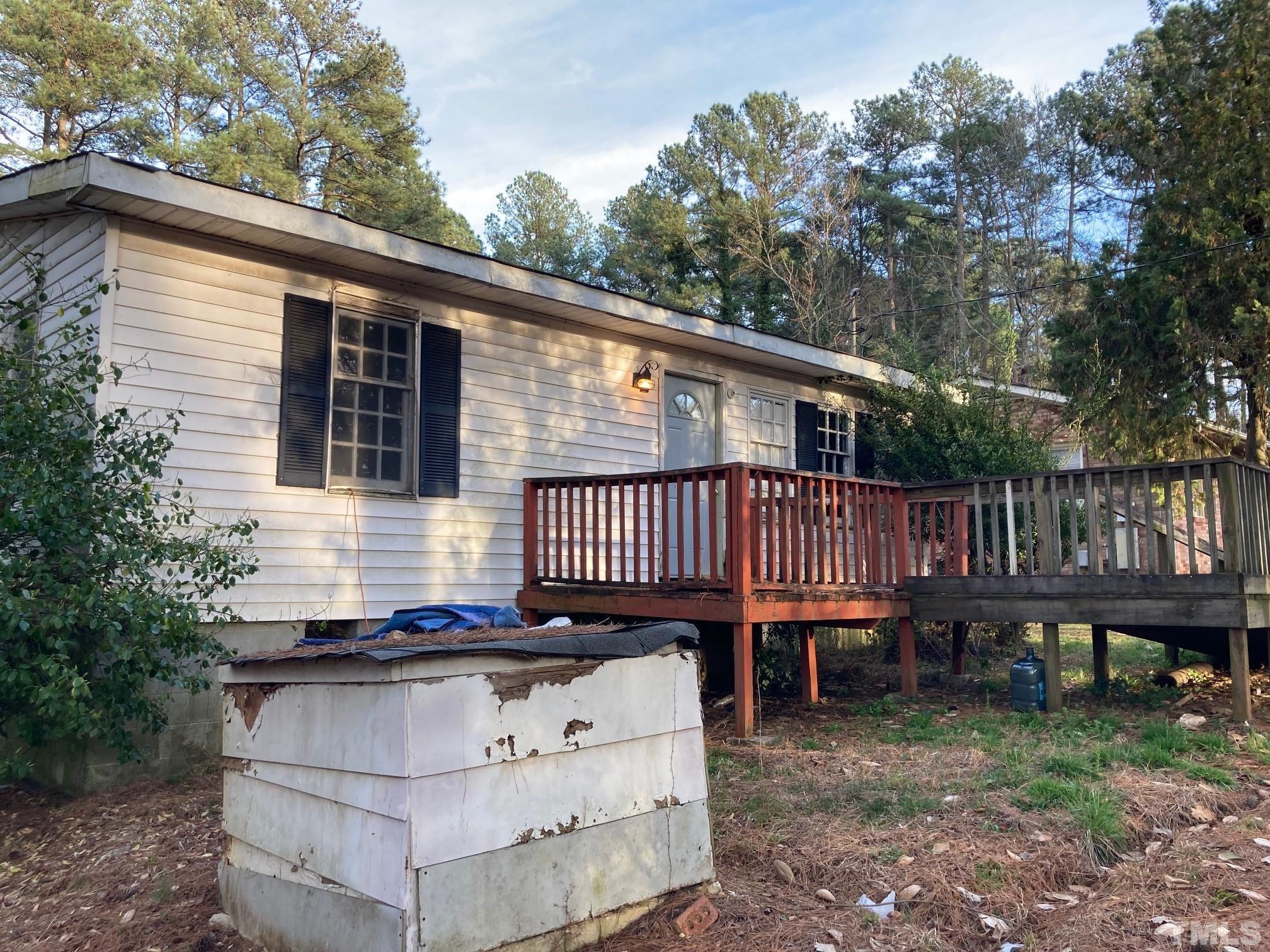11512 Hickory Grove Church Road Raleigh, NC 27613 - Photo 17 of 17 a view of a house with a deck and a yard