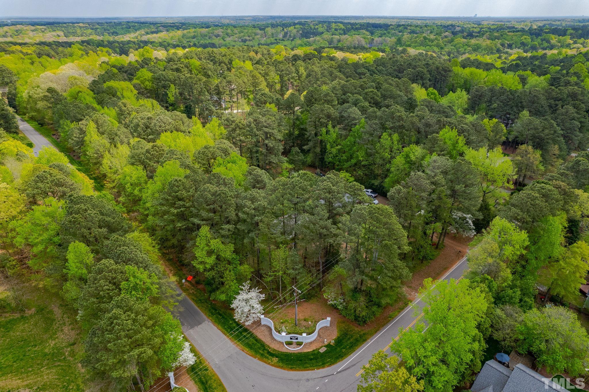 11512 Hickory Grove Church Road Raleigh, NC 27613 - Photo 2 of 17 an aerial view of residential houses with outdoor space and trees
