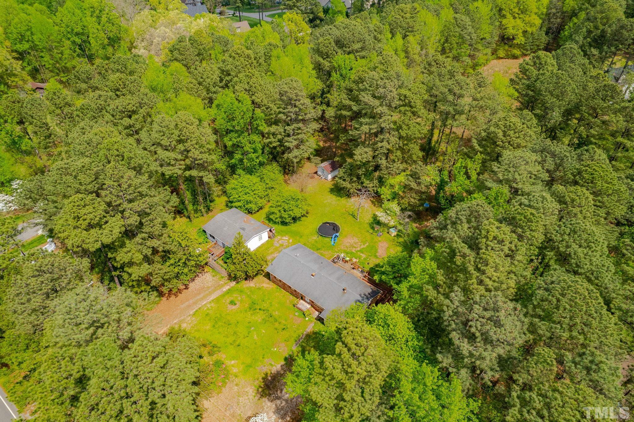 11512 Hickory Grove Church Road Raleigh, NC 27613 - Photo 8 of 17 a backyard of a house with large trees and plants