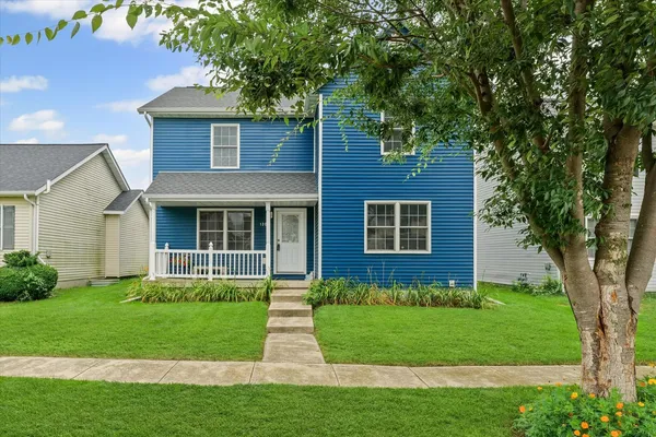 a front view of a house with a yard