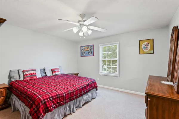 a bedroom with a bed and a window