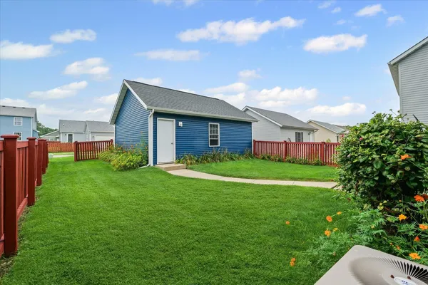 a view of a house with a backyard