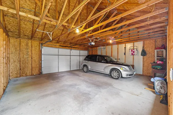 a view of parking garage with cars parked