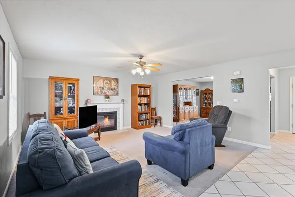 a living room with furniture and a chandelier