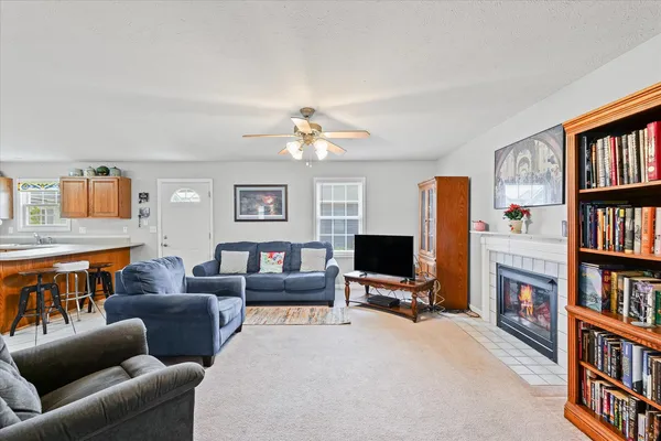 a living room with furniture a window and a book shelf