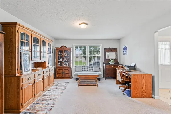 a bedroom with furniture and a large window
