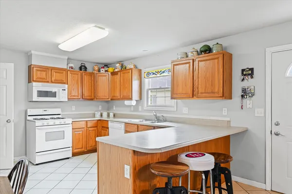 a kitchen with stainless steel appliances granite countertop a sink and a refrigerator