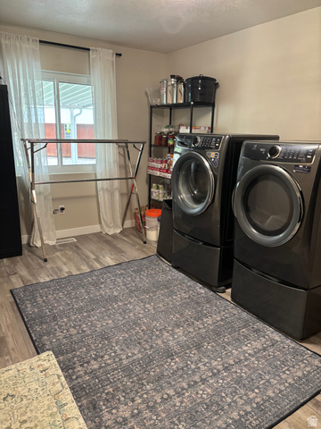 1324 West Raintree Drive, Unit 44 Price, UT 84501 - Photo 11 of 25 Utility space featuring wood-finish flooring and a white-framed window with sheer curtains