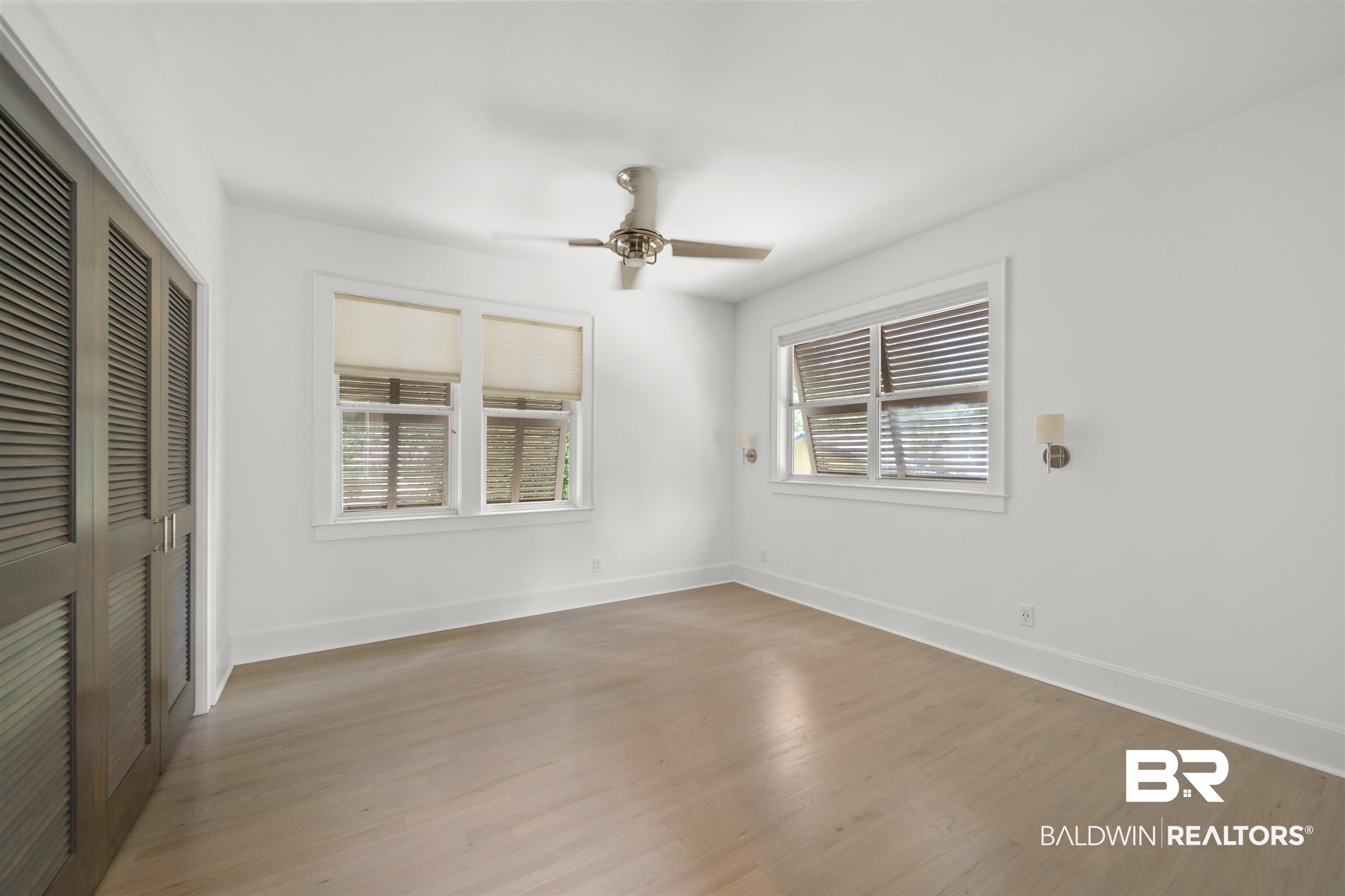 106 White Avenue Fairhope, AL 36532 - Photo 19 of 35 Unfurnished bedroom featuring a closet, light wood-type flooring, and a ceiling fan