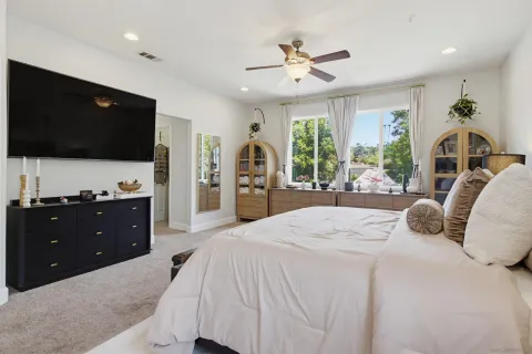 a bathroom with a granite countertop sink a toilet and a mirror