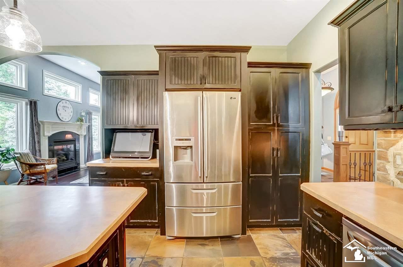 6475 Douglas Road Lambertville, MI 48144 - Photo 13 of 39 Large, open kitchen with plenty of storage in distressed cabinetry.