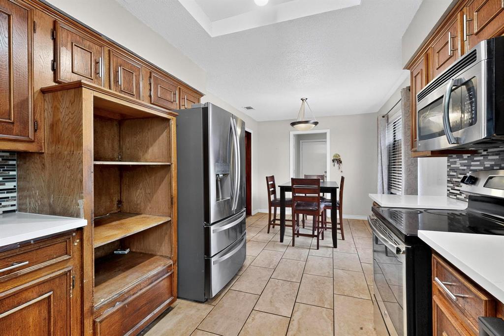 865 Harlan Road Combine, TX 75159 - Photo 12 of 38 a kitchen with stainless steel appliances granite countertop a refrigerator and a stove top oven