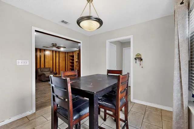 a view of a dining room with furniture and window