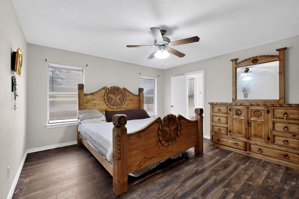 865 Harlan Road Combine, TX 75159 - Photo 15 of 38 a living room with furniture a bed and dresser