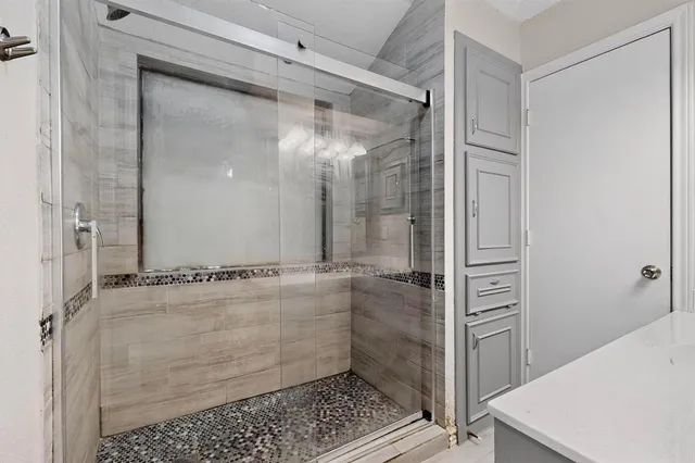 a bathroom with a glass shower door