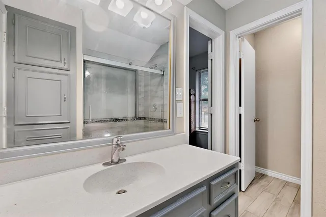 a bathroom with a sink and a mirror