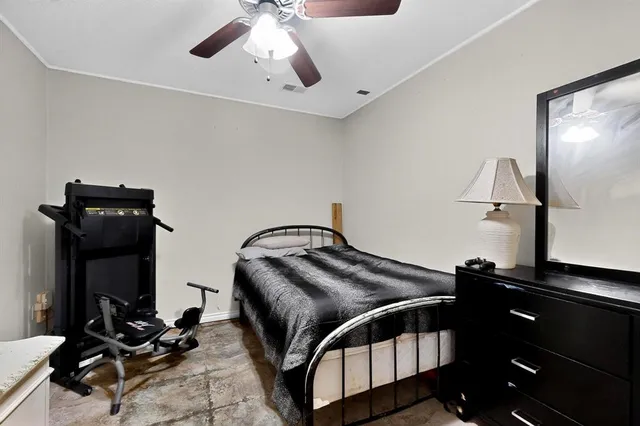 a bedroom with a bed and a desk