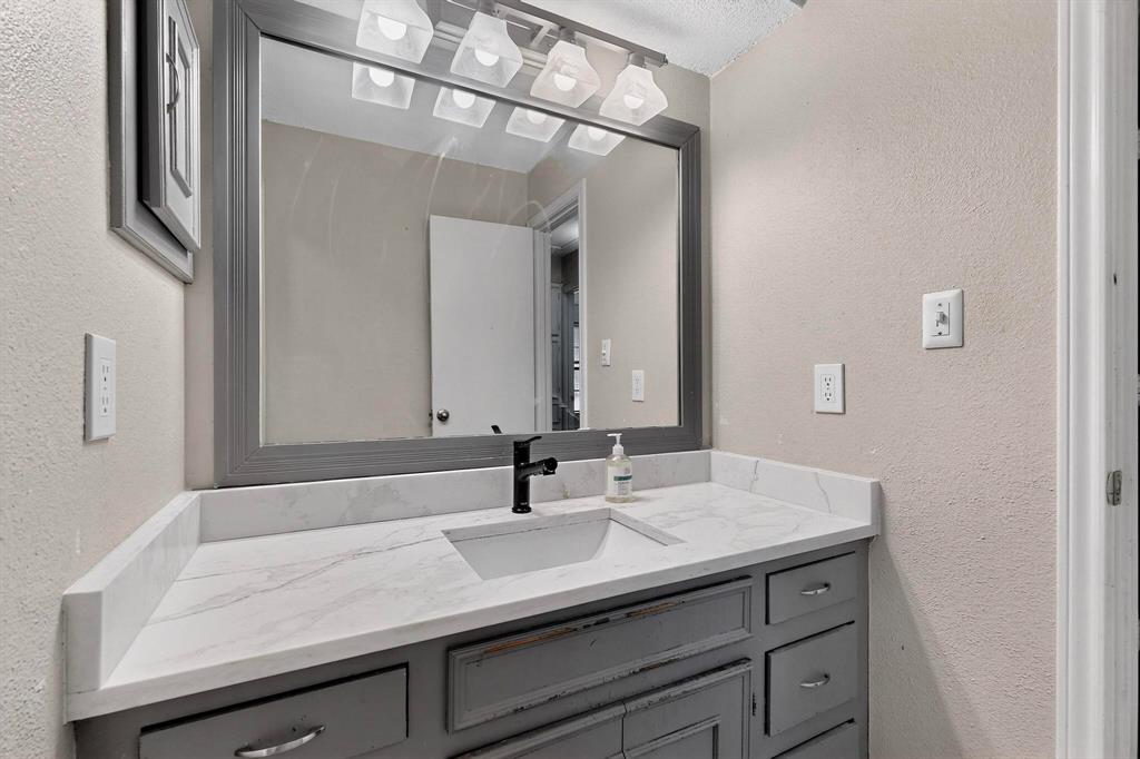 865 Harlan Road Combine, TX 75159 - Photo 25 of 38 a bathroom with a sink and a mirror