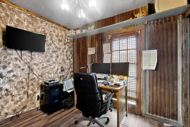 a view of a workspace with furniture and a window