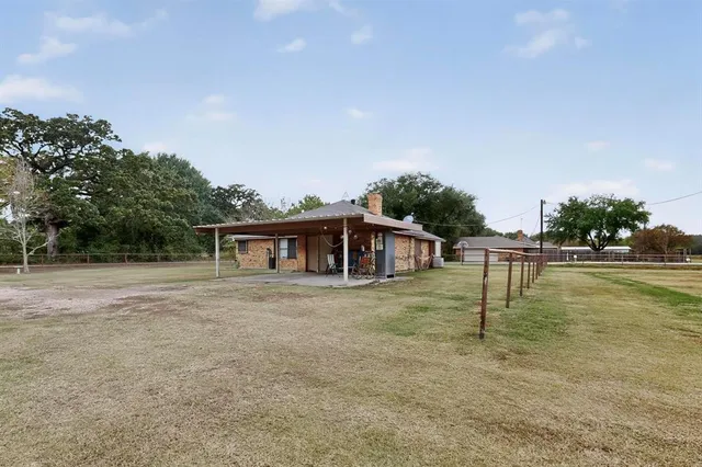 a view of a field with trees in the background