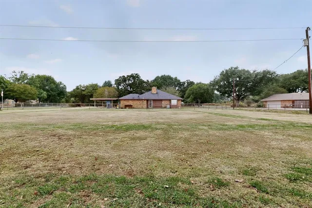 a view of a field with an trees