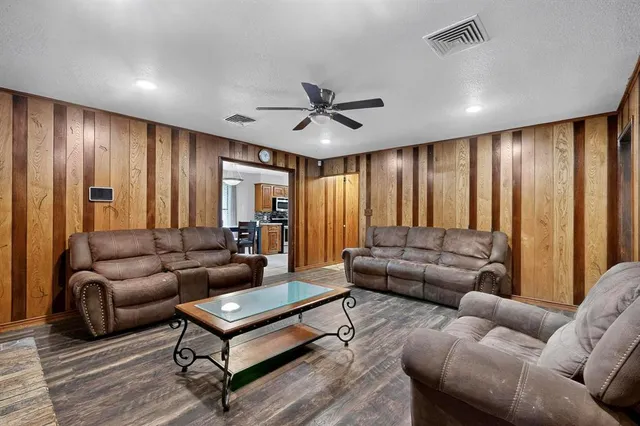 a living room with furniture and a ceiling fan